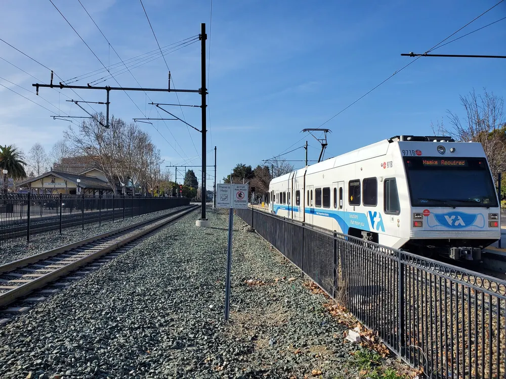 A VTA Orange Line train at the Mountain View light rail platform, next to the Caltrain tracks